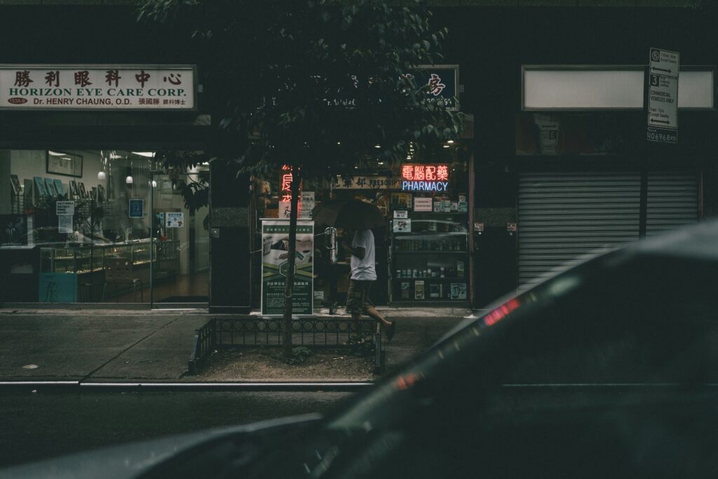 Composition of T-shirts, bags, and accessories lined up against a white background with bright reflections